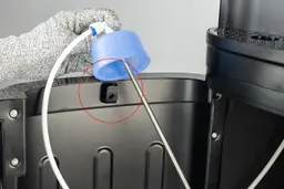 The hook on the door of a bottom-loading water cooler dispenser. 