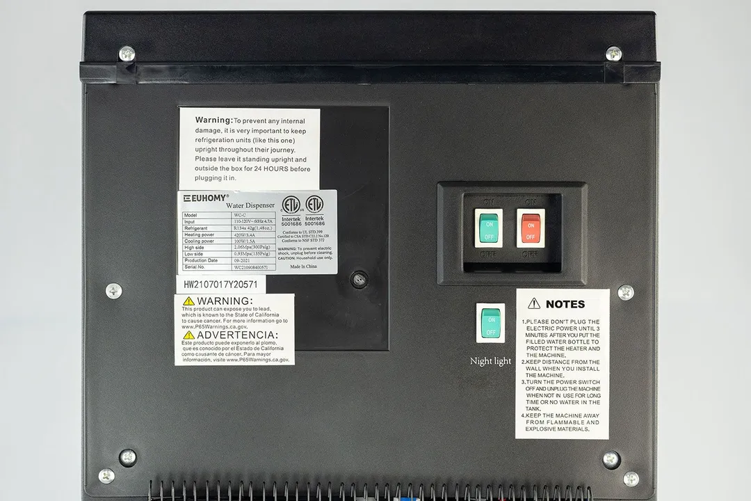 Three switches on the rear of a water cooler dispenser. Tank switches are to the top right and the night switch below.