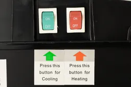 Close up of two color-coded buttons at the rear of a water cooler dispenser with clear labeling for operation. 