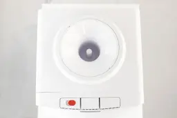 Top down view of a countertop water cooler dispenser showing the water guard and water needle. 