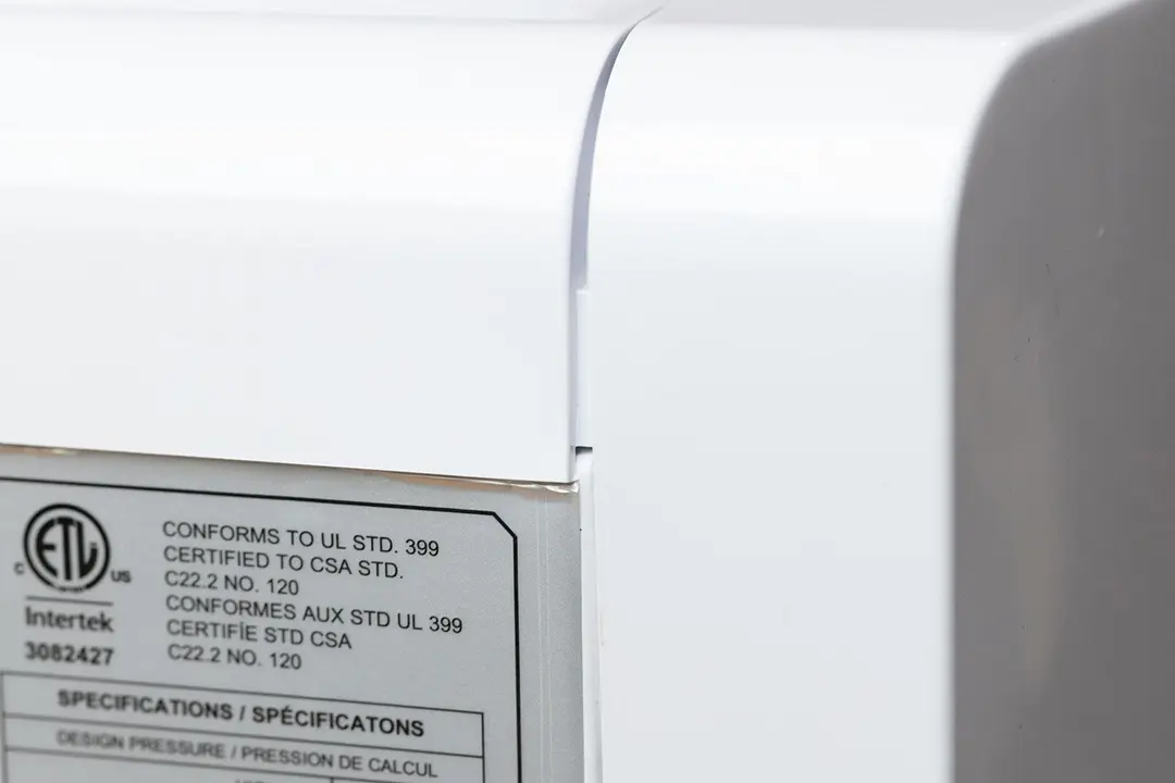 A close up side view of a countertop water cooler dispenser focuses on a poor joining seam. 