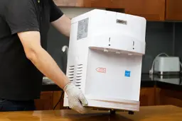 A demonstration of how to move the Igloo countertop water cooler dispenser with no side handles.