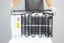 A man holding the electric cable of a small water cooler dispenser double folded across its horizontal length.