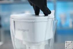 gloved hand lifting the Aquagear spout cover