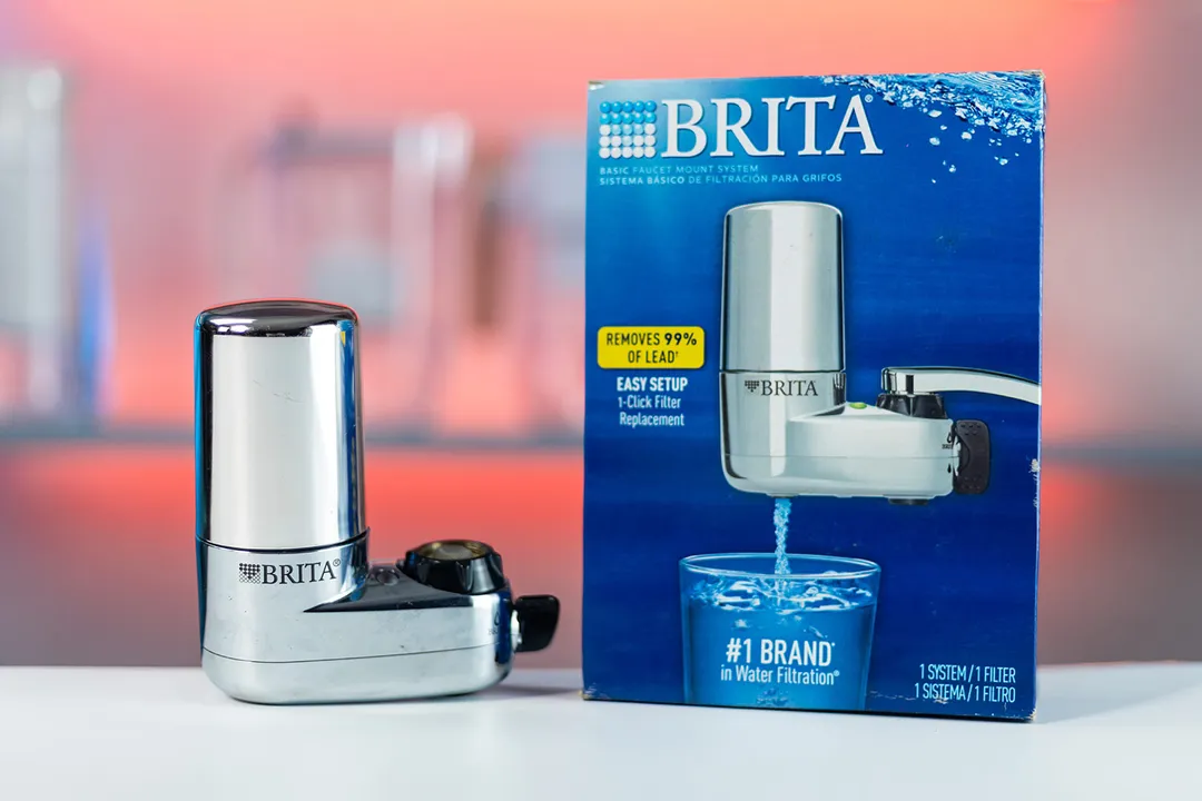 The Brita Basic filter to the left, with its shipping box to the right against a blurry background.