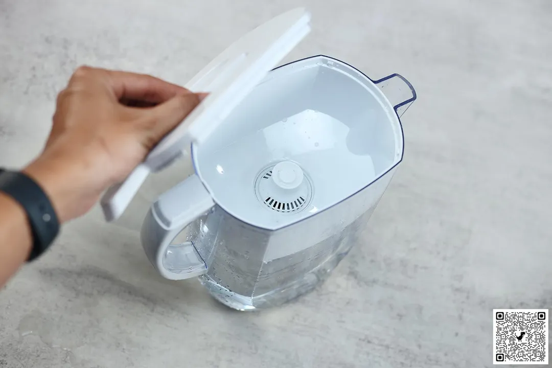 hand holding and opening lid of Brita Everyday pitcher