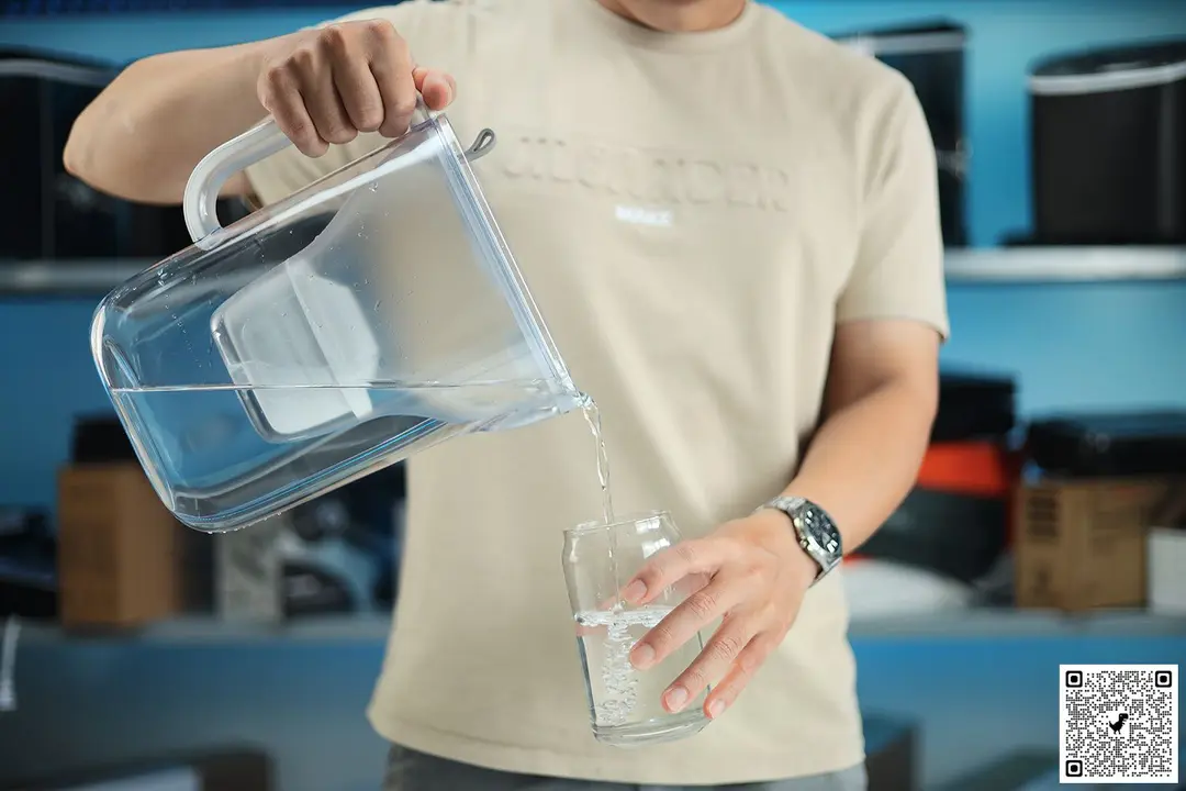 Person pouring water from the Brita Style water jug to a glass