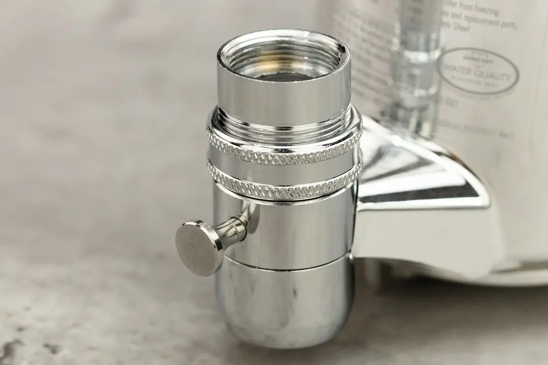 The Culligan FM-25 faucet-mount water faucet with a faucet adapter attached to the filter’s mounting port.
