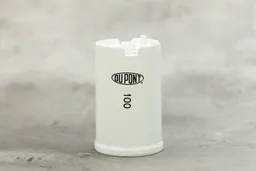 The white plastic filter cartridge that comes with the filter. Printed on it are the DuPont logo and the number 100.