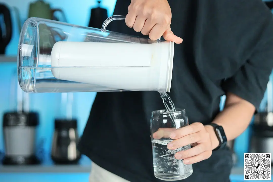 Person holding the LifeStraw pitcher and pouring water into a glass
