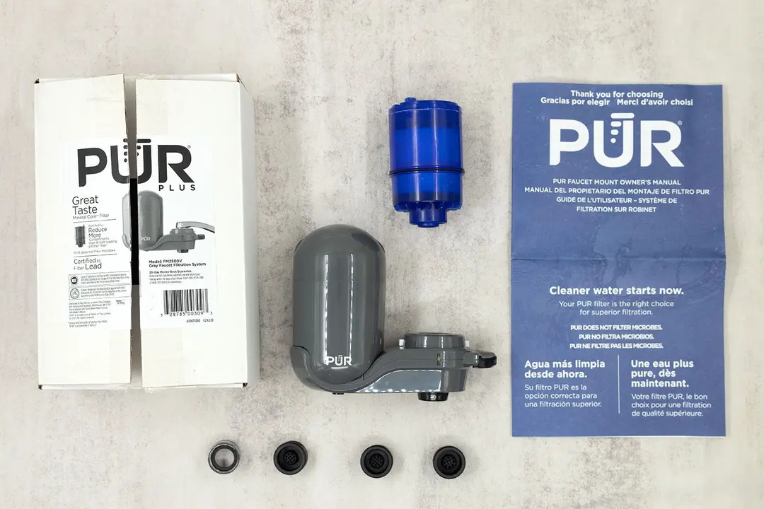 The grey PUR PFM350V filter is in the middle, surrounded by its accessories, manuals, and the shipping box.