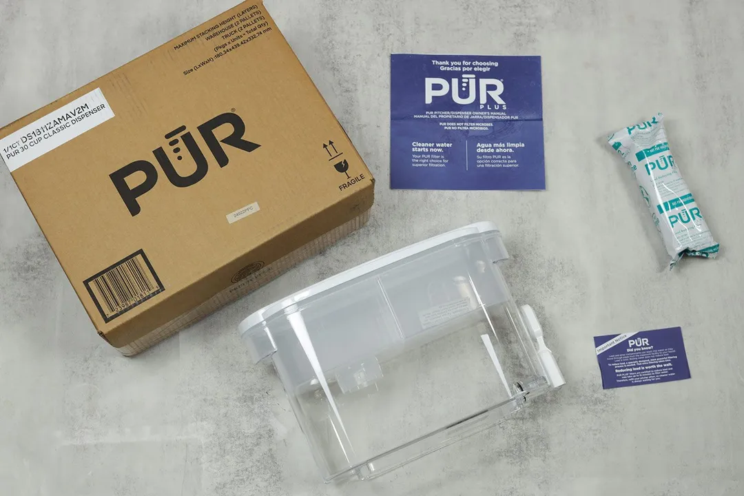 The PUR Plus dispenser, its package box, filter piece, promotional leaflets