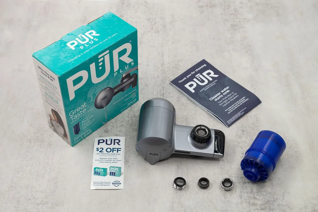 The grey PUR PFM350V filter is in the middle, surrounded by its accessories, manuals, and the shipping box.
