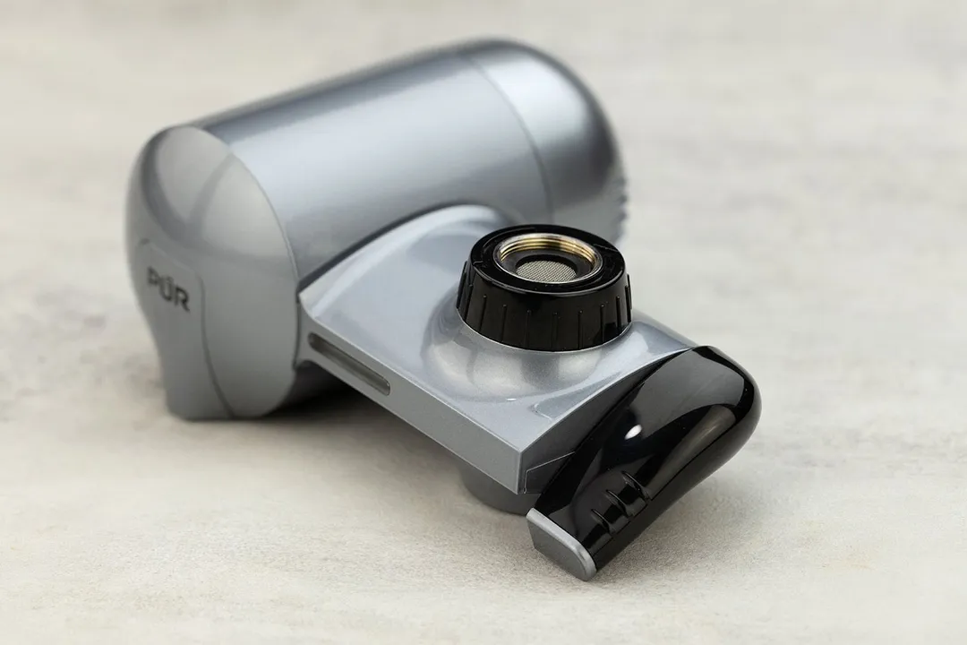 A close-up shot on the black rotating handle of the PUR Plus PFM350V faucet-mount water filter.