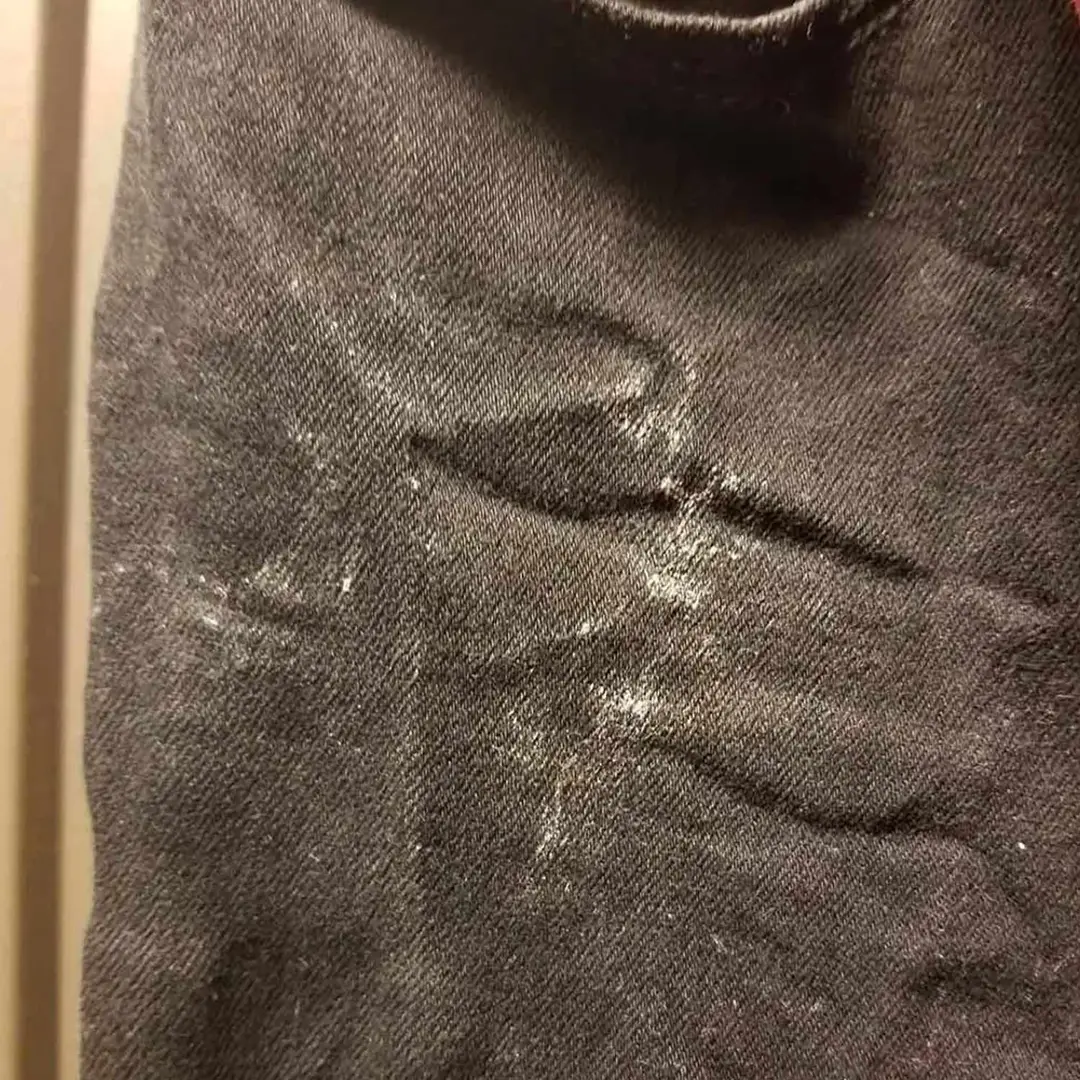 Streaks of white calcium on clothes washed with hard water