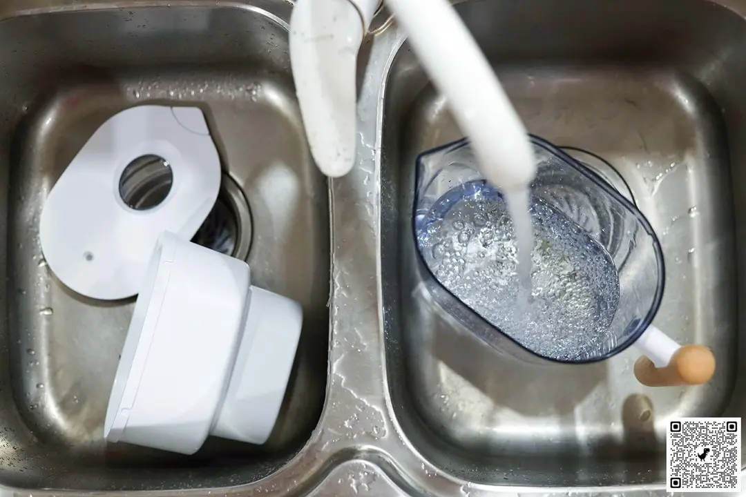 Parts of the Waterdrop Chubby water filter pitcher in a duo-sink, with water running and foam in the pitcher
