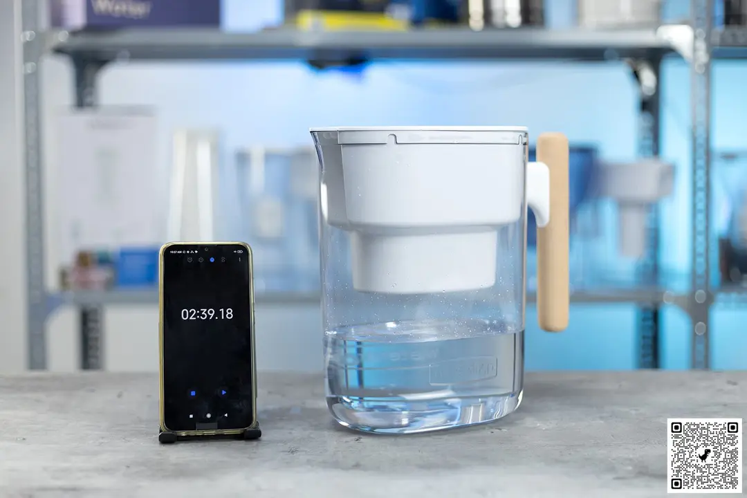 Waterdrop water filter pitcher next to a phone with timer