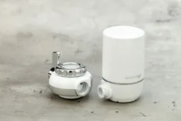 The disassembled parts of the Waterdrop WD-FC-01 faucet-mount water filter. The connection port on both parts is visible.