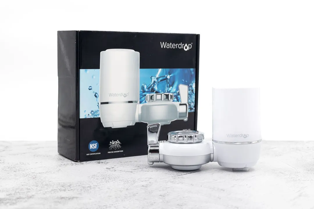 The fully-assembled Waterdrop WD-FC-01 faucet water filter is in the foreground. In the background is its shipping box.