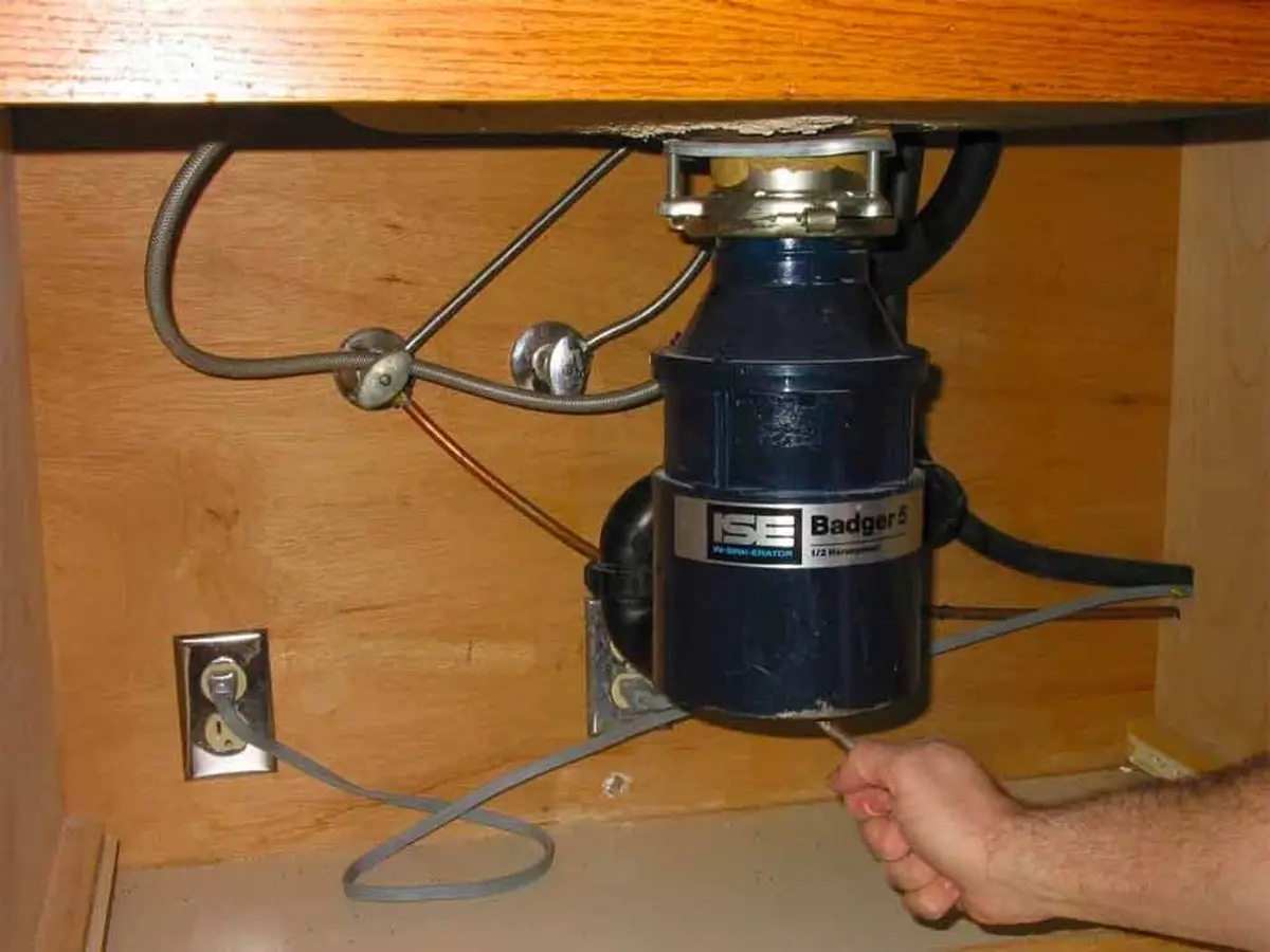 The power switch of a garbage disposal unit.