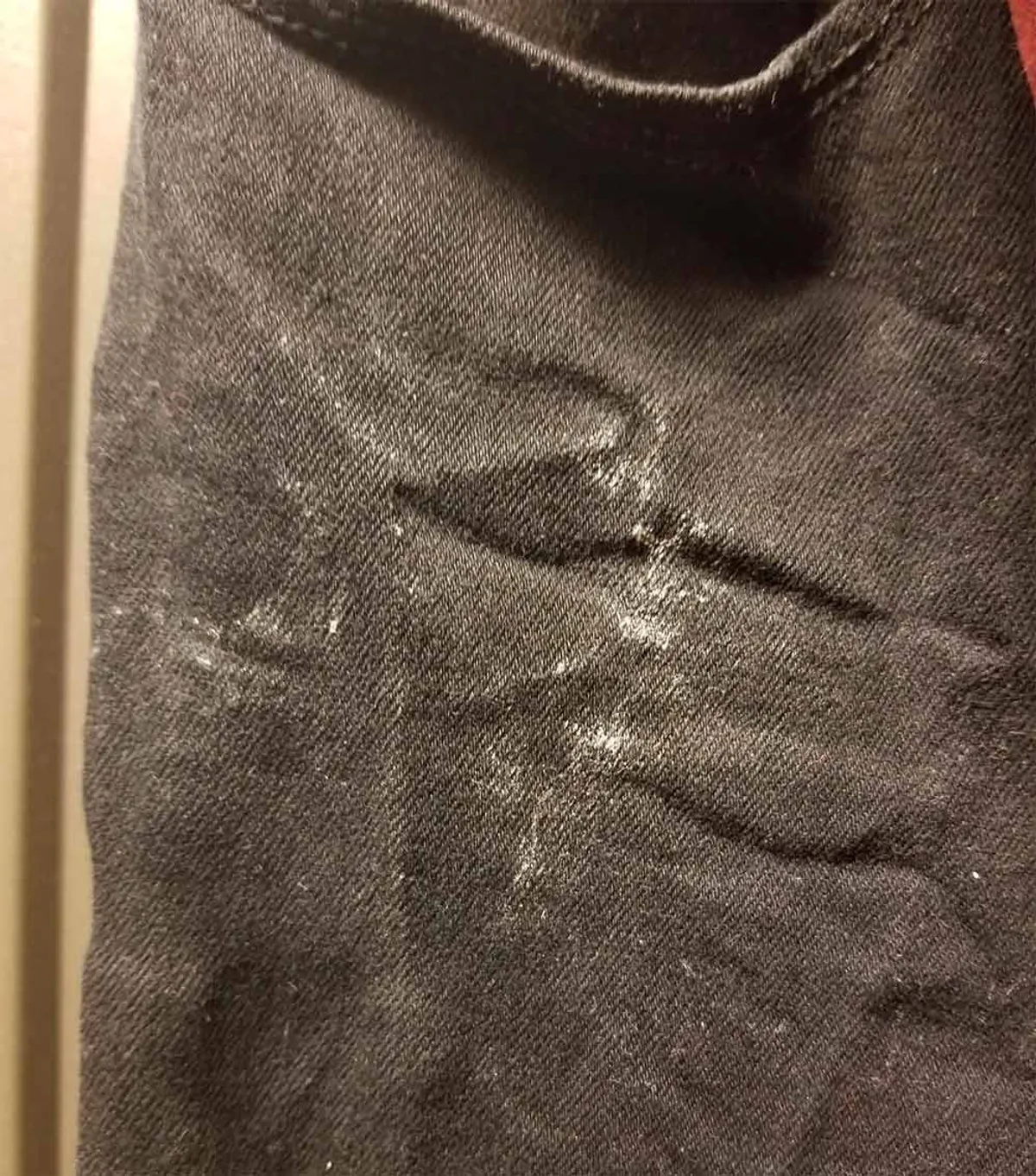 Streaks of white calcium on clothes washed with hard water