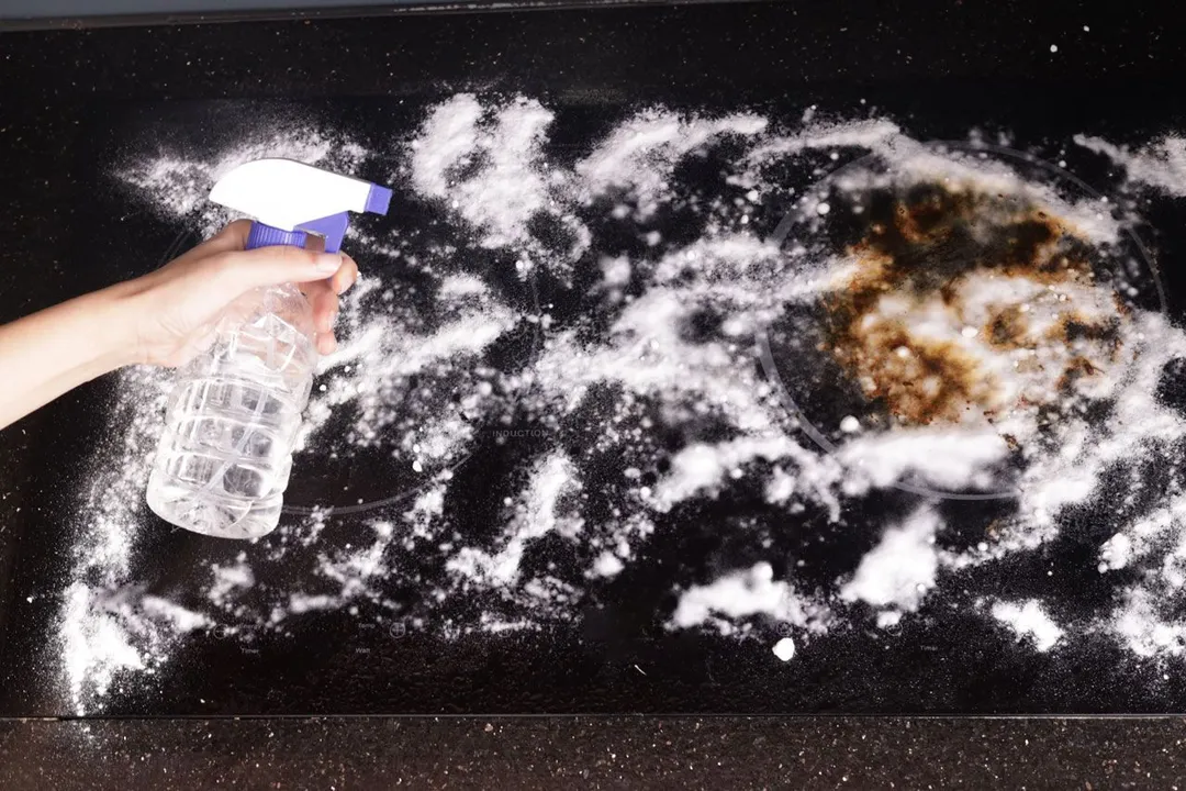 Electric Stove Top with a Layer of Dry Baking Soda and White Vinegar